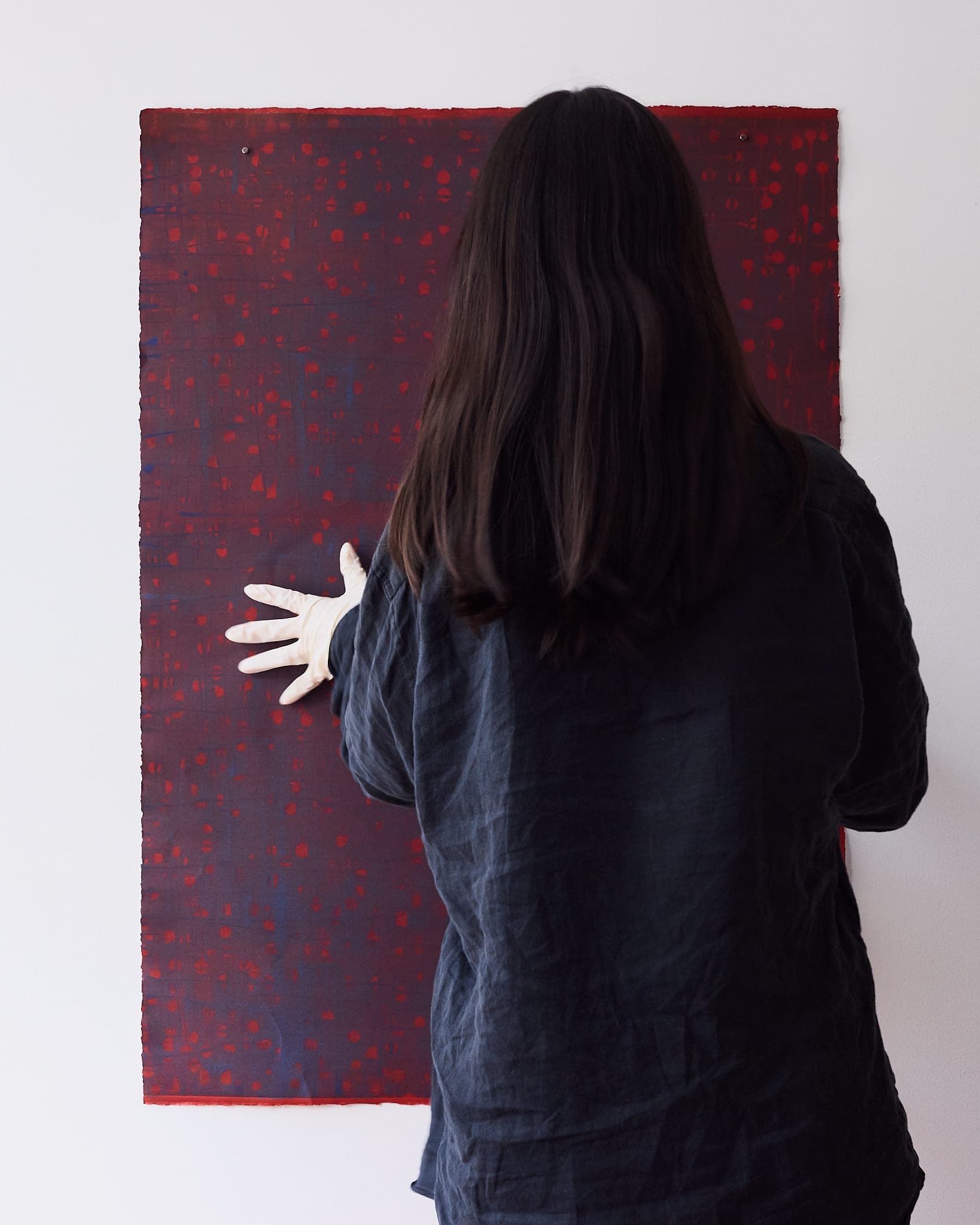 Selin Salci with a large monotype in her studio
